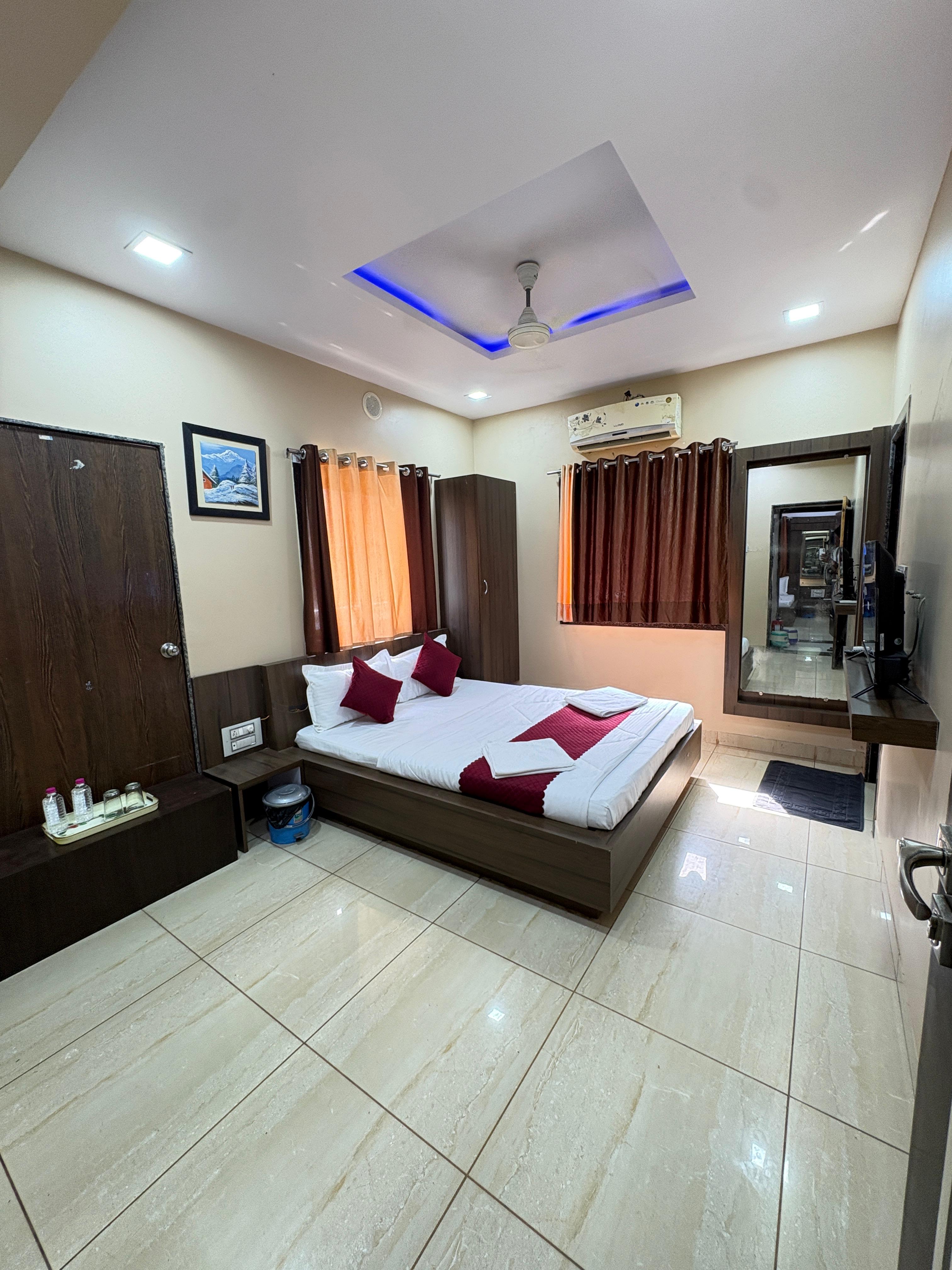 Deluxe Balcony AC Room with a king bed and terrace doors